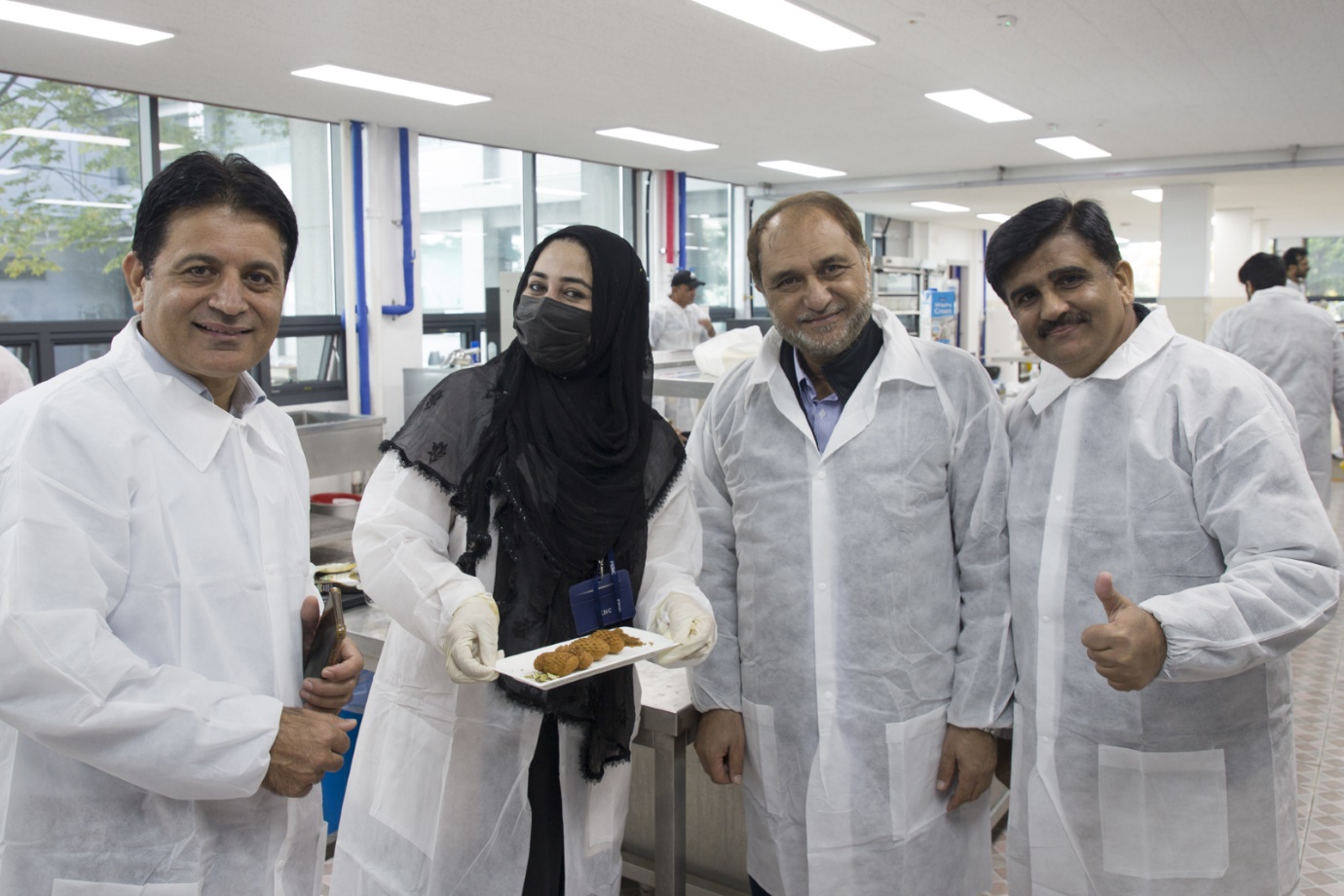 Pakistani nutrition experts posing with finished food.